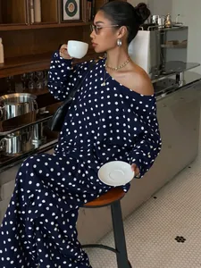 Casual navy blue lounge suit with white polka dots and slanted neck in a café setting.