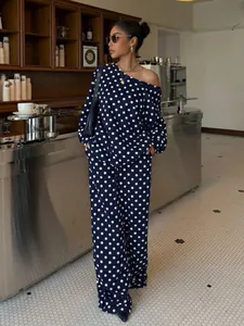Navy blue polka dot lounge set with off-shoulder sweatshirt and wide-leg trousers.