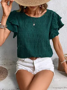 Close-up of dark green smocked top featuring elegant double ruffle flutter sleeves