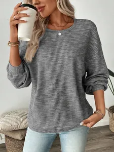 Detailed view of a grey waffle-knit long-sleeve T-shirt featuring a relaxed and cozy fit