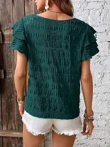 Back view of an elegant dark green smocked blouse featuring double ruffle sleeves
