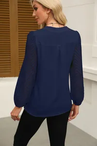 Detailed back view of navy blue chiffon top featuring sheer chevron lace sleeves