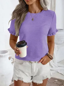 Detail of purple textured T-shirt with ruffle sleeves worn with white denim shorts