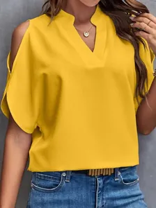 Close-up of women's bright yellow V-neck chiffon blouse with cold shoulder design
