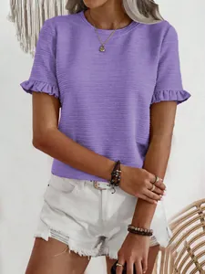 Detailed macro view of purple t-shirt featuring textured fabric and ruffled sleeve cuffs