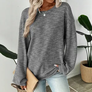 Casual gray waffle knit loose fit long sleeve T-shirt for women in a lifestyle setting