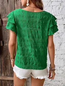 Detailed back view of a vibrant green textured casual top with stylish double ruffle sleeves