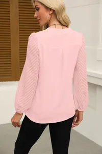 Detailed back view of a pink V-neck chiffon blouse featuring elegant chevron lace sleeves