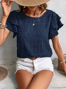 Detail showing the dark blue pleated texture and ruffled sleeves of this casual top