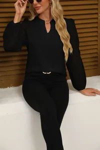 Detailed view of women's black V-neck chiffon blouse featuring elegant lace patchwork sleeves