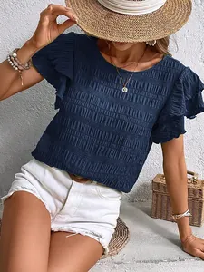 Close-up detail of navy blue casual blouse featuring textured fabric and ruffled sleeves.