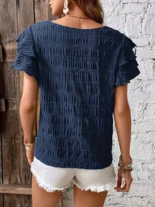 Back view detail of casual navy blue blouse with ruffled sleeves and smocked texture