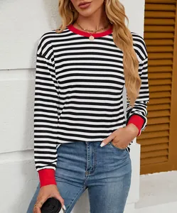 Detail view of a striped long-sleeve shirt featuring a red contrast crew neck collar.