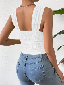 Back view of a white sleeveless cropped tank top showing detailed smocked fabric design