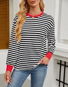 Chic black and white striped long-sleeve top with red contrast cuffs and neckline.