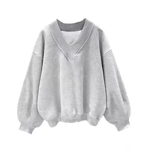 Detailed view of grey V-neck fleece sweatshirt with ribbed cuffs and lantern sleeves