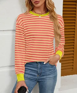 Close-up view of pink and yellow striped long sleeve top with contrast ribbed cuffs