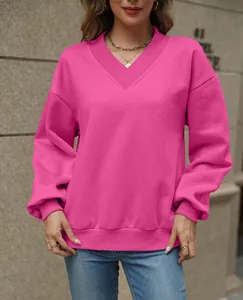 Stylish women's V-neck loose fleece sweatshirt in vibrant pink, casual fall wear.