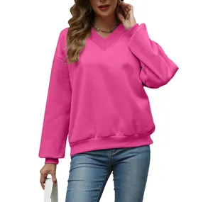 Detail view of women's bright pink V-neck loose fit sweatshirt for casual autumn wear