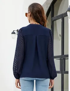 Detailed back view of a navy blue chiffon blouse with elegant chevron lace sleeves.
