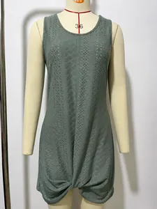 Detailed view of the hollow-out knit texture and twist hem on a green beach dress.