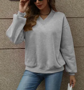 Detail view of grey V-neck loose sweatshirt for women, perfect for autumn casual styling.