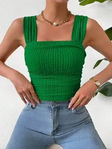 Close-up detail of a bright green smocked crop top featuring a square neck and wide straps