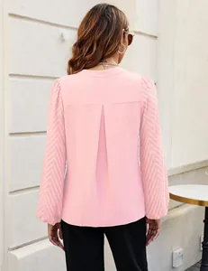 Detailed back view of an elegant pink chiffon blouse with textured lace puff sleeves.