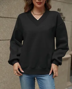 Front view detail of a loose black V-neck fleece sweatshirt on a model