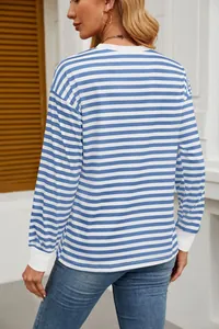 Back view of a casual blue and white striped long sleeve shirt on a fashion model