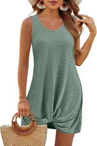 Detail view of a sage green hollow-out beach dress with a stylish twist knot hem.