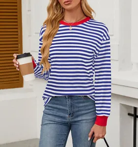 Detail view of women's blue and white striped top with red contrast collar and loose fit