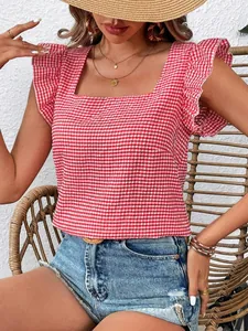 Detailed view of a red and white gingham square neck blouse with ruffle sleeves on model