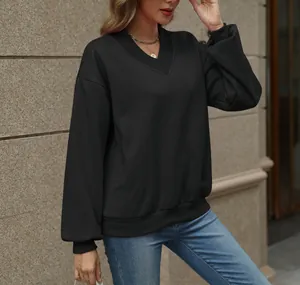 Detail of women's oversized black V-neck sweatshirt with soft fleece lining