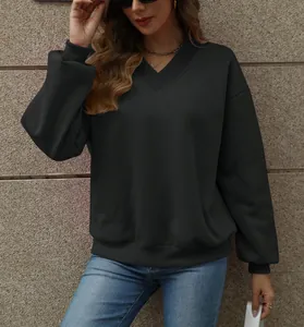 Detail of the V-neckline and textured black fabric on this oversized women's fleece sweatshirt