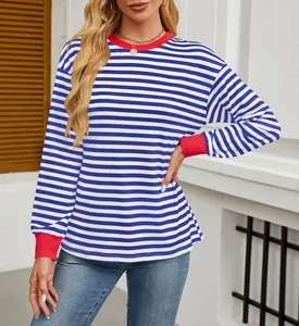 Detailed view of women's blue and white striped long sleeve top with red contrast cuffs.