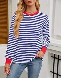 Front detail of a loose striped top with vibrant red ribbed neck and sleeve cuffs