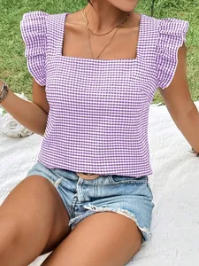 Detailed view of a purple gingham square neck blouse with ruffled flutter sleeves.