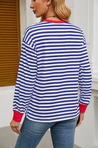 Back view of a fashionable striped long-sleeve top with red contrast cuffs and neckline.