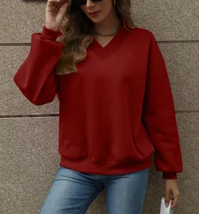 Close-up of red V-neck fleece sweatshirt with ribbed details on neckline and cuffs