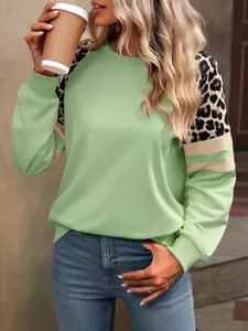 Détail du sweat-shirt vert menthe avec manches raglan léopard et rayures contrastées