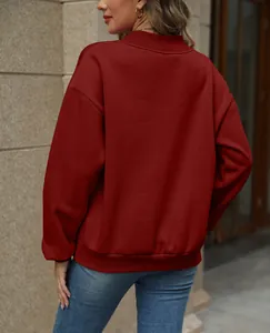 Back view detail of a warm burgundy oversized sweatshirt with ribbed hem and cuffs