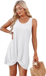 White sleeveless hollow-out beach vacation dress featuring a unique front knot hem detail