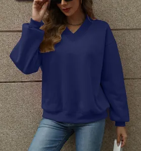 Detail view of women's loose dark blue V-neck sweatshirt with ribbed cuffs
