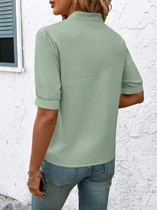 Detailed back view of a sage green short sleeve cotton shirt with textured fabric