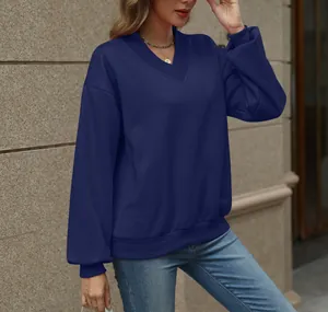 Detail of a navy blue women's V-neck sweatshirt with an oversized fleece-lined design
