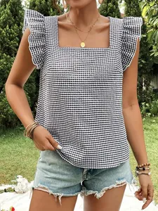 Close-up detail of black and white gingham top featuring square neck and ruffle sleeves.