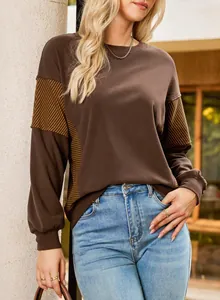 Detailed view of women's brown sweatshirt with stylish striped paneling on the sleeves.