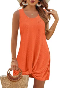 Detail of orange sleeveless beach dress with hollow eyelet pattern and twist knot hem
