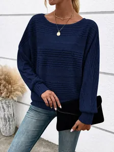 Close-up showing the texture of a navy blue ribbed sweater with batwing sleeves